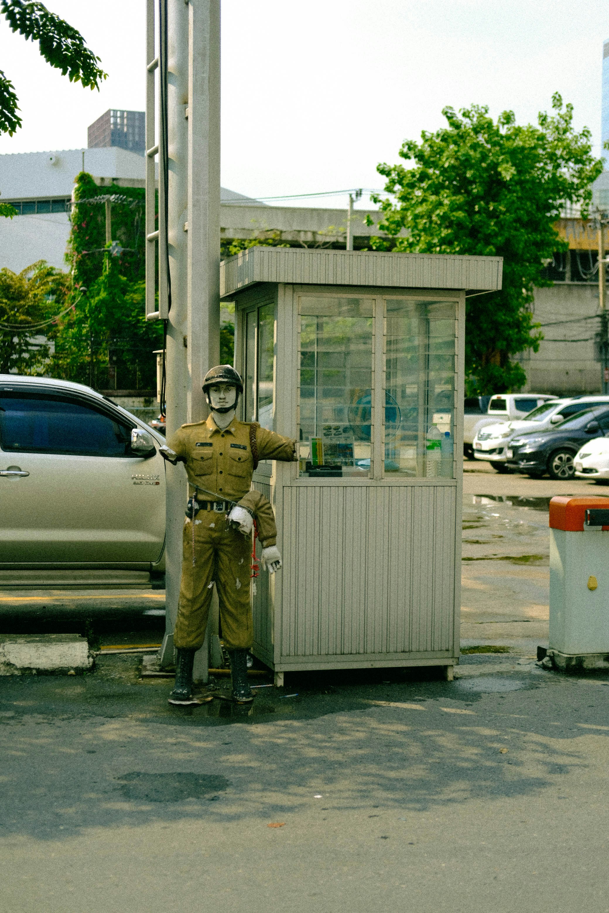 A man in uniform standing next to a small building photo – Free Car ...