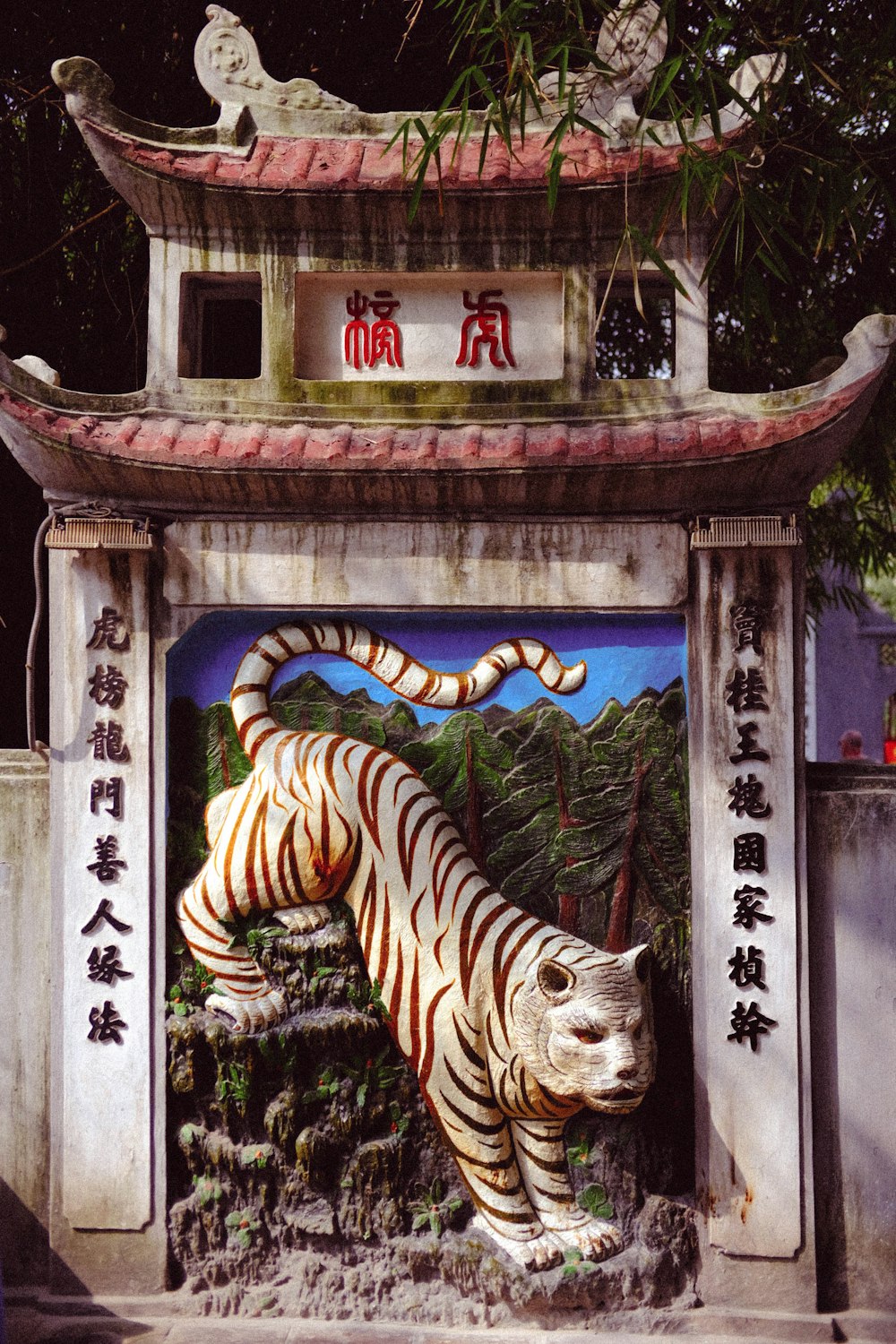 a statue of a tiger in front of a pagoda