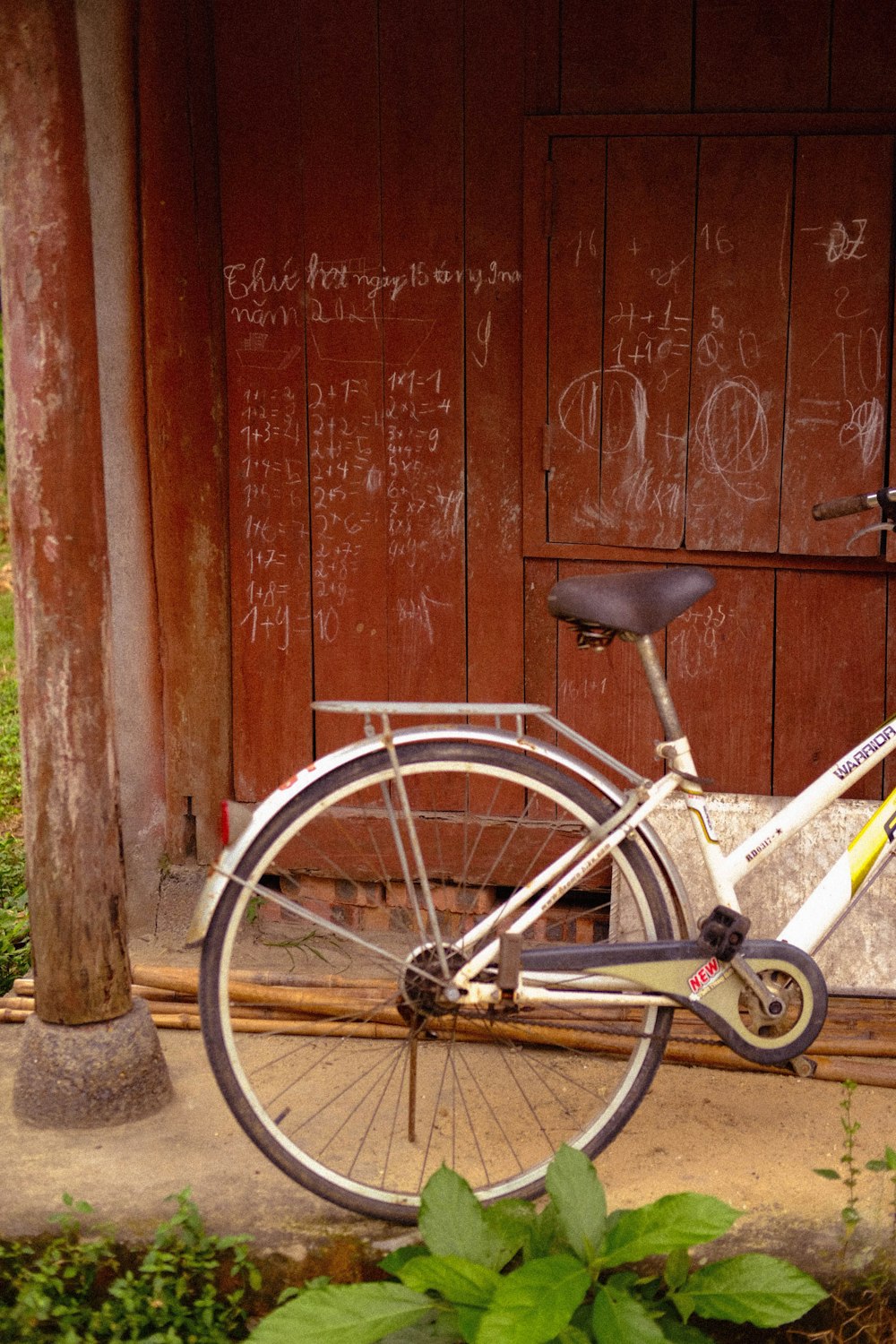 a bicycle parked in front of a wooden building
