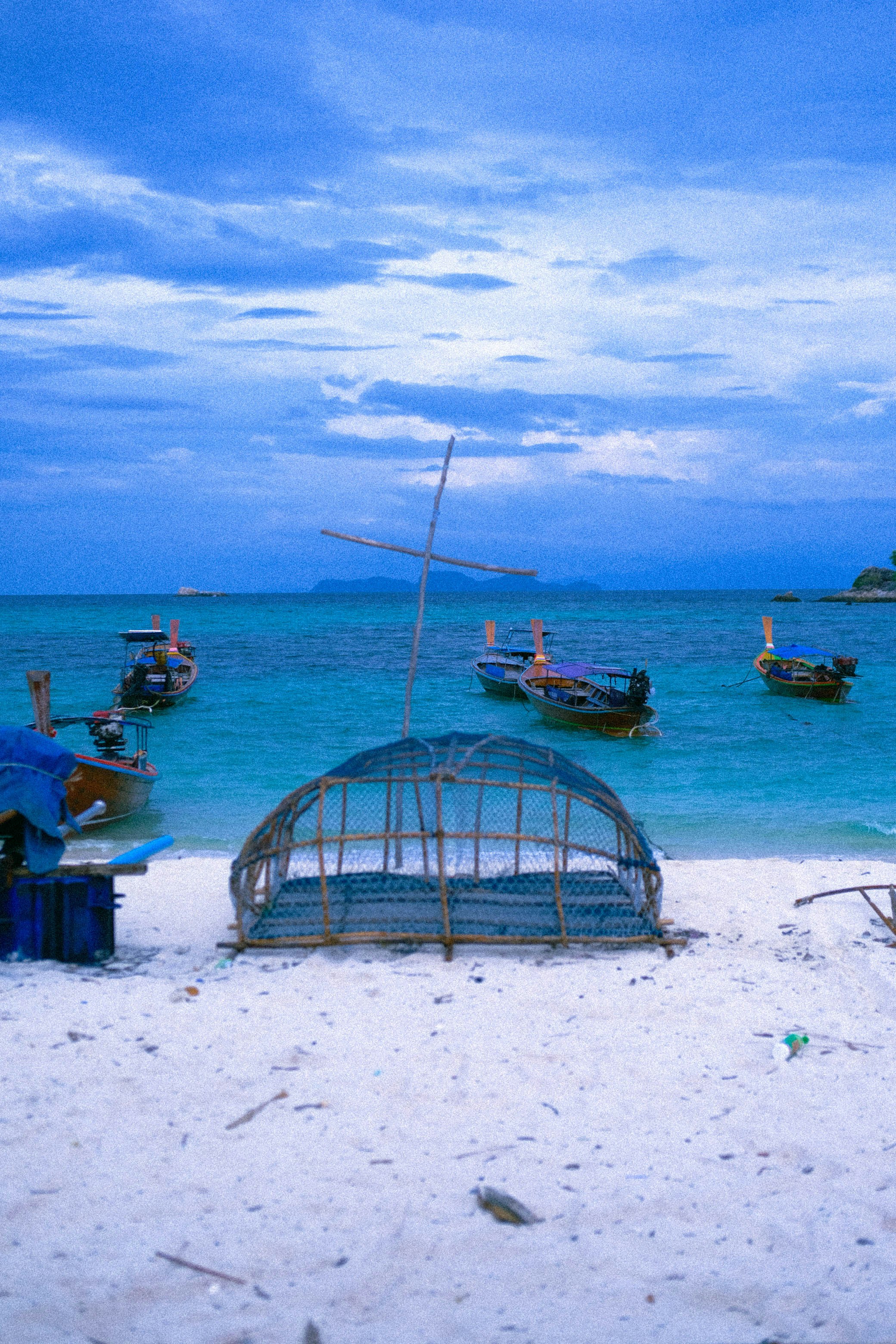 a group of boats sitting on top of a sandy beach
