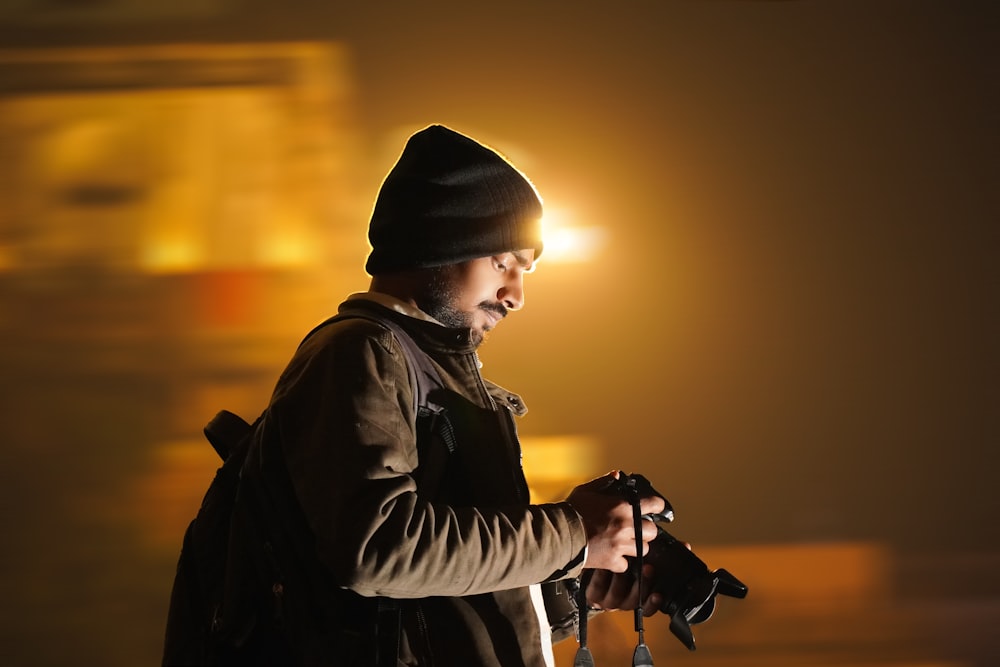 a man holding a camera in his right hand