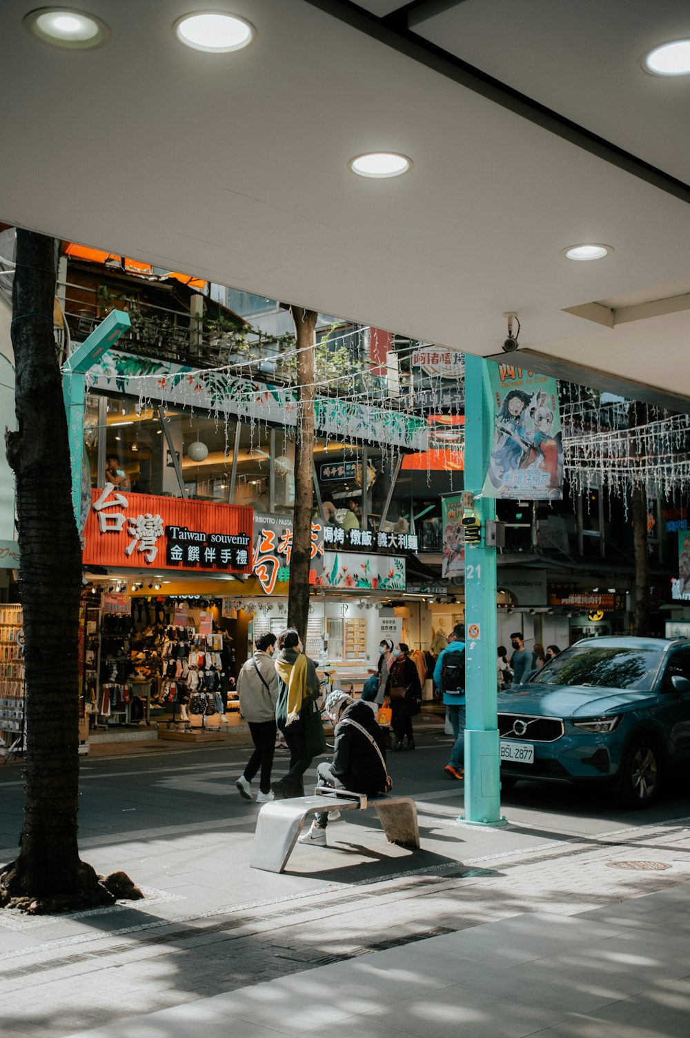 a man sitting on a bench in front of a store