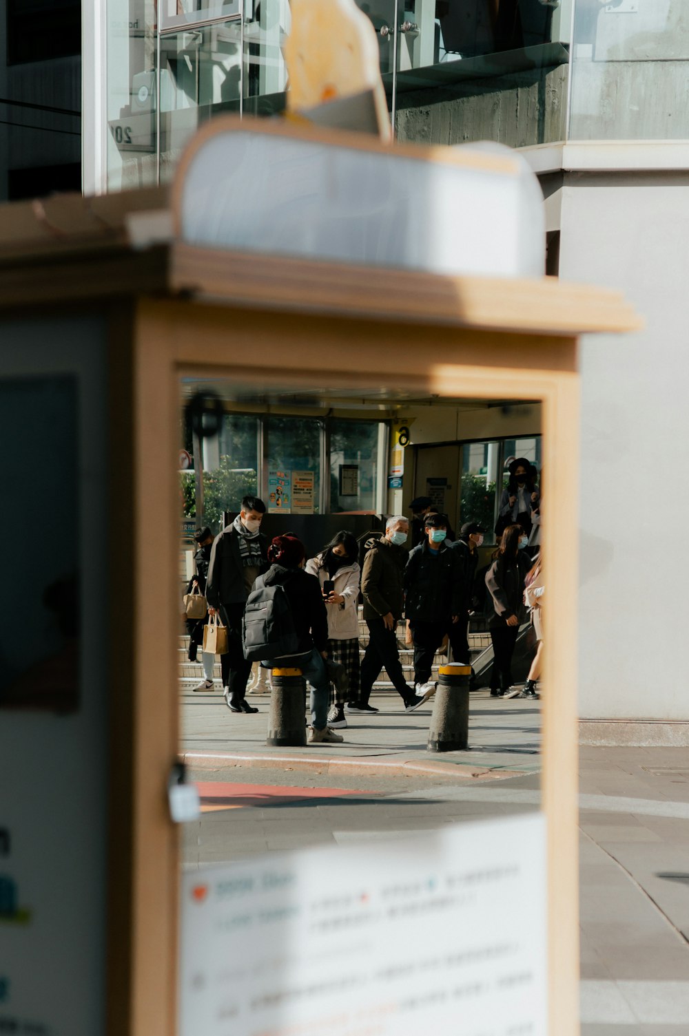 a group of people walking across a street