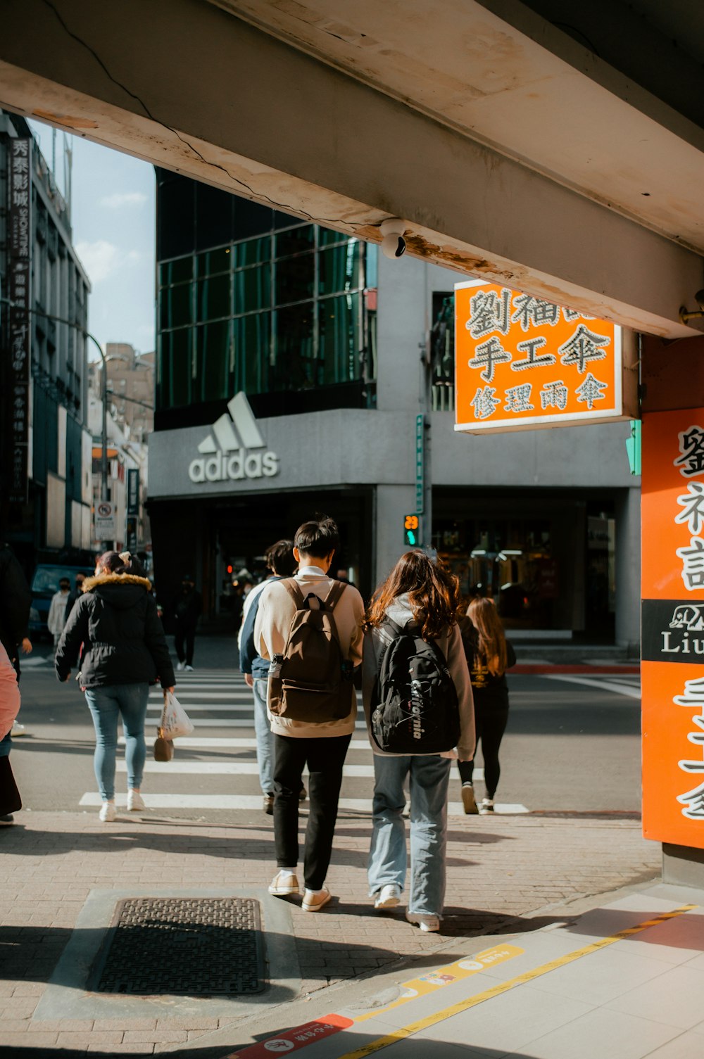 a group of people walking across a street