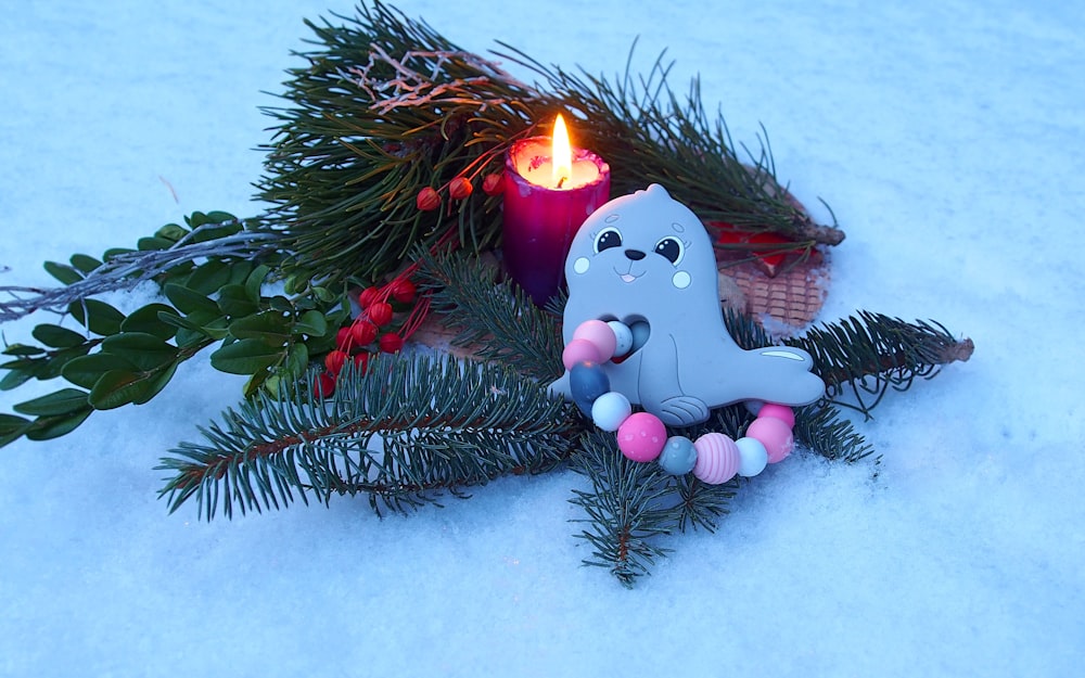 a toy elephant sitting on top of a snow covered ground