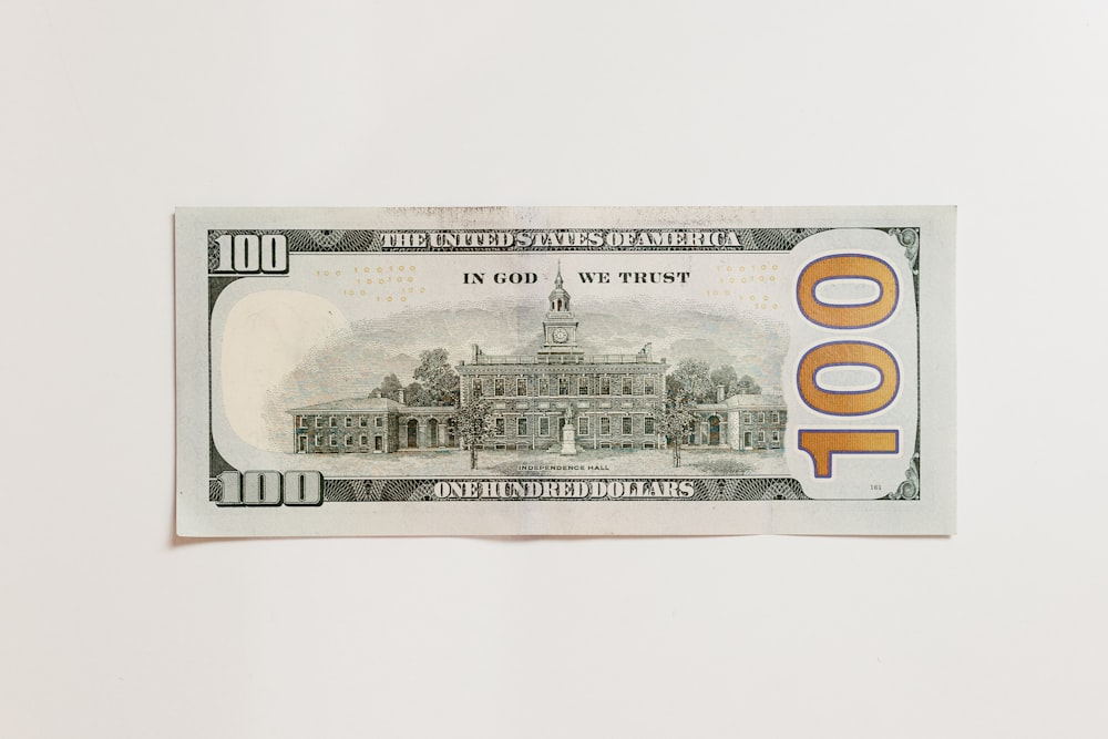 a one hundred dollar bill with a picture of a building on it