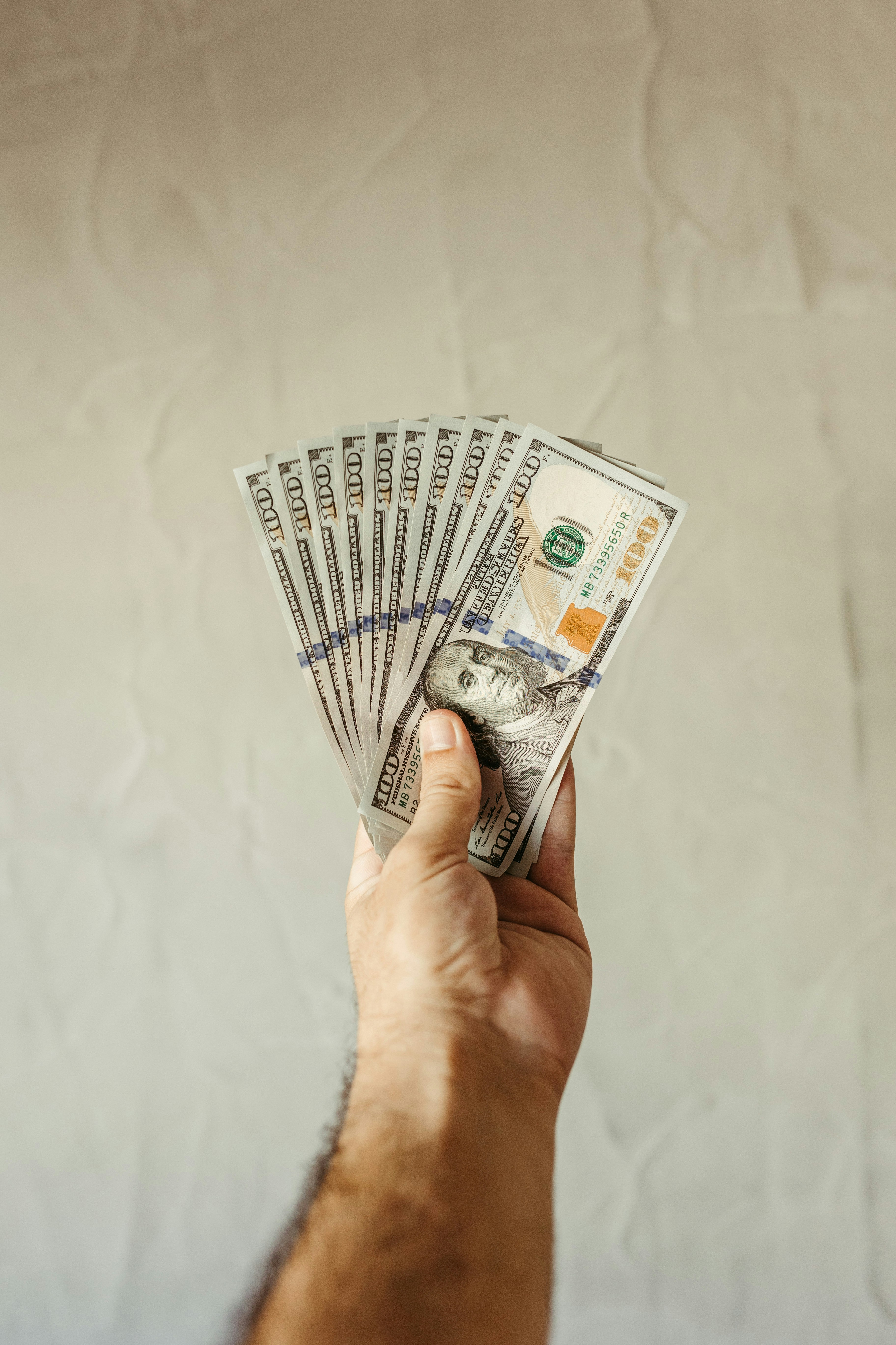 a person holding a bunch of money in their hand