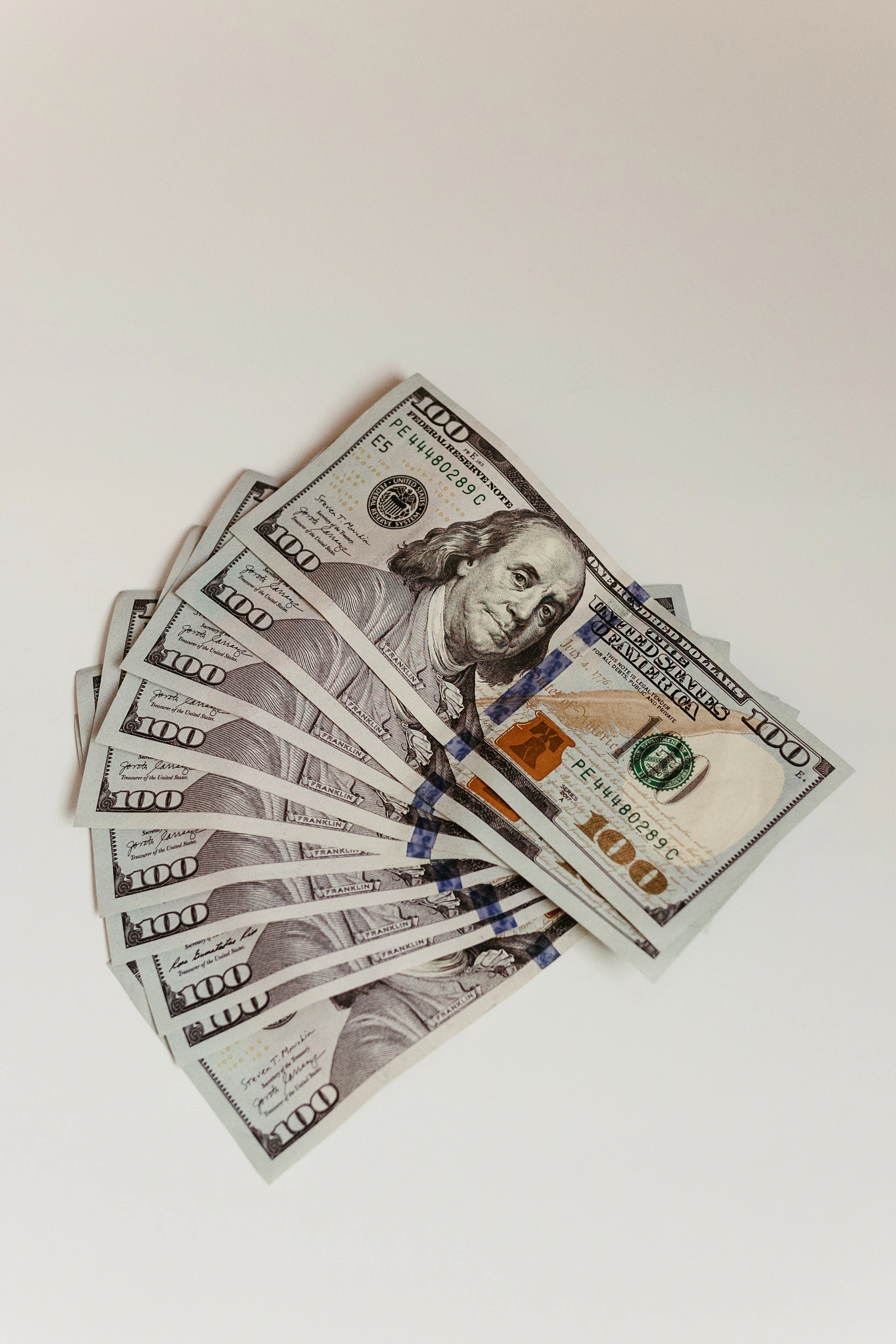a stack of twenty dollar bills sitting on top of each other