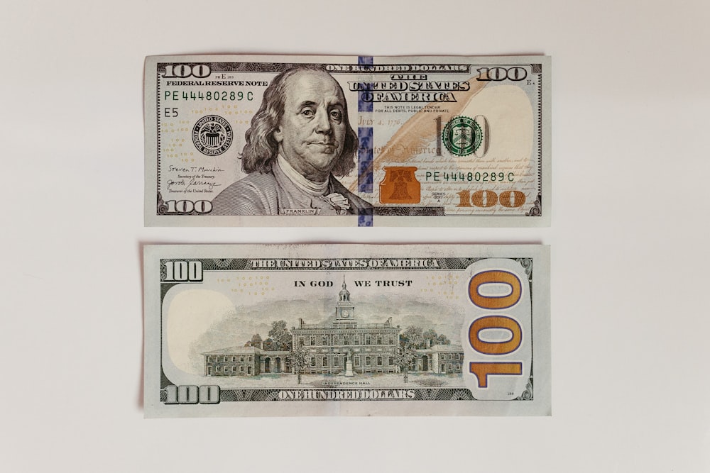 two bills with a picture of a president and a 100 dollar bill