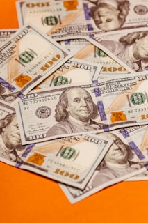 a pile of twenty dollar bills sitting on top, MBA Healthcare Management Salary