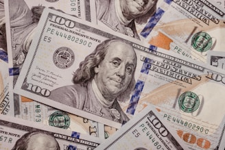 a pile of one hundred dollar bills