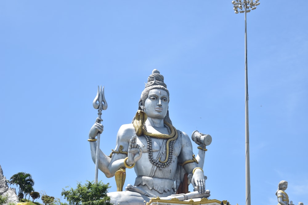 a statue of a hindu god with a sword in his hand