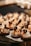 Creamy desserts topped with whipped cream and blackberries are neatly arranged on a plate. The desserts are drizzled with a golden caramel sauce, and each base is dusted with powdered sugar.