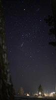 Close-up of an oil painting depicting the Orion constellation glowing against a deep midnight blue sky.