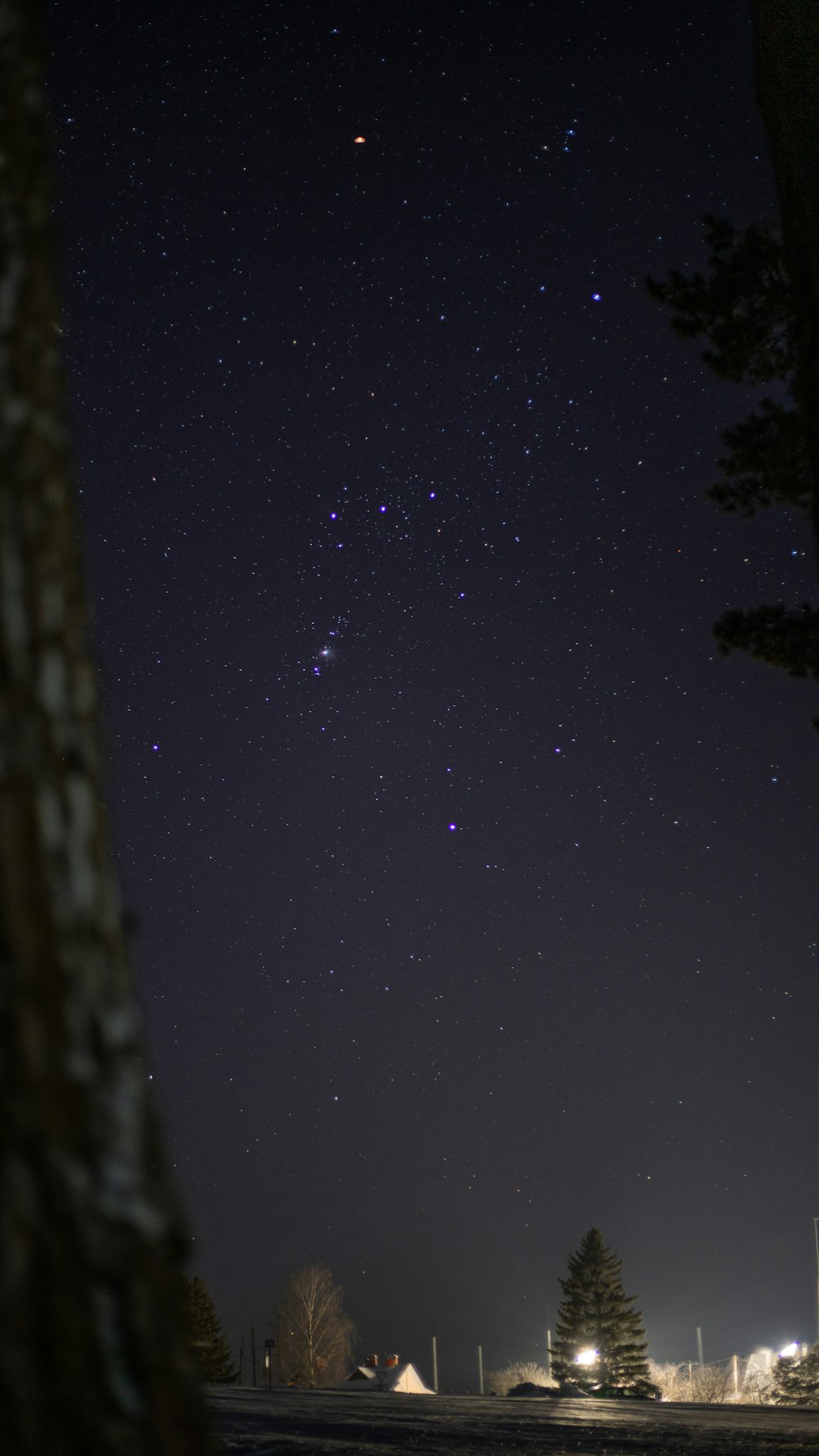 the night sky with a few stars in the distance