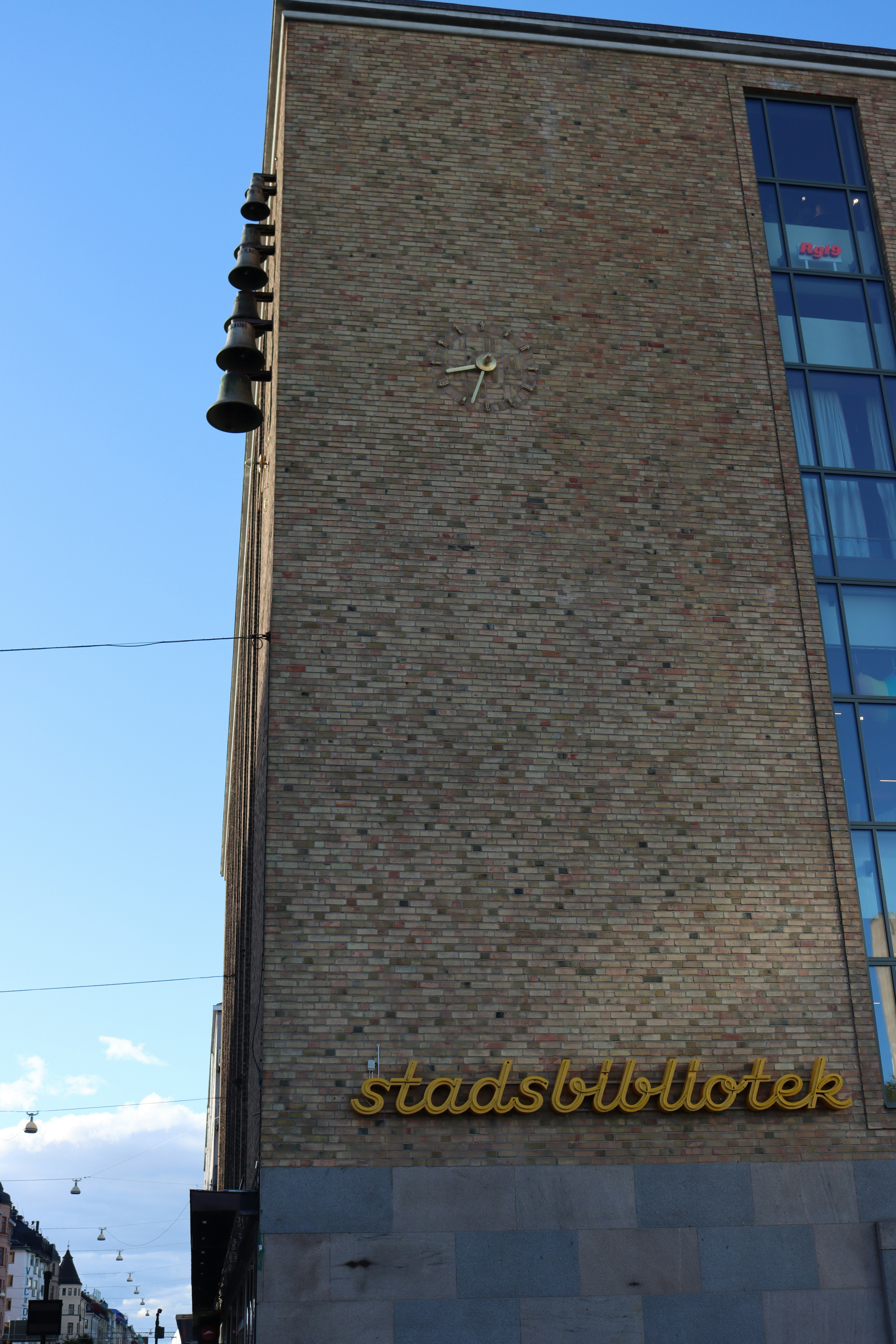 a tall brick building with a clock on the side