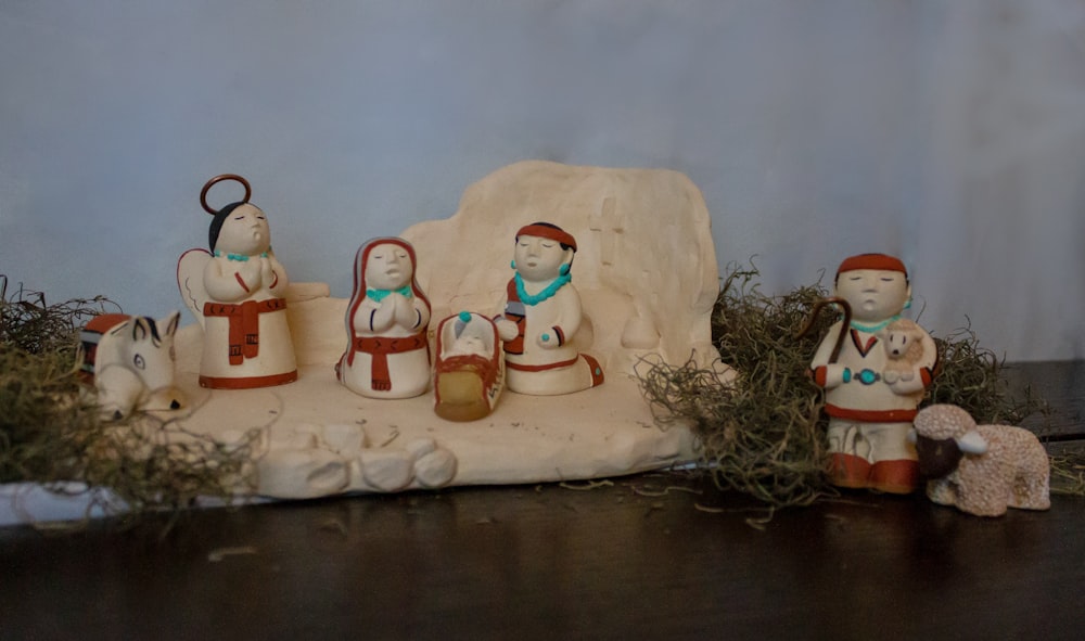 a group of figurines sitting on top of a table