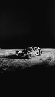 High-contrast image of car parts arranged on a black surface.