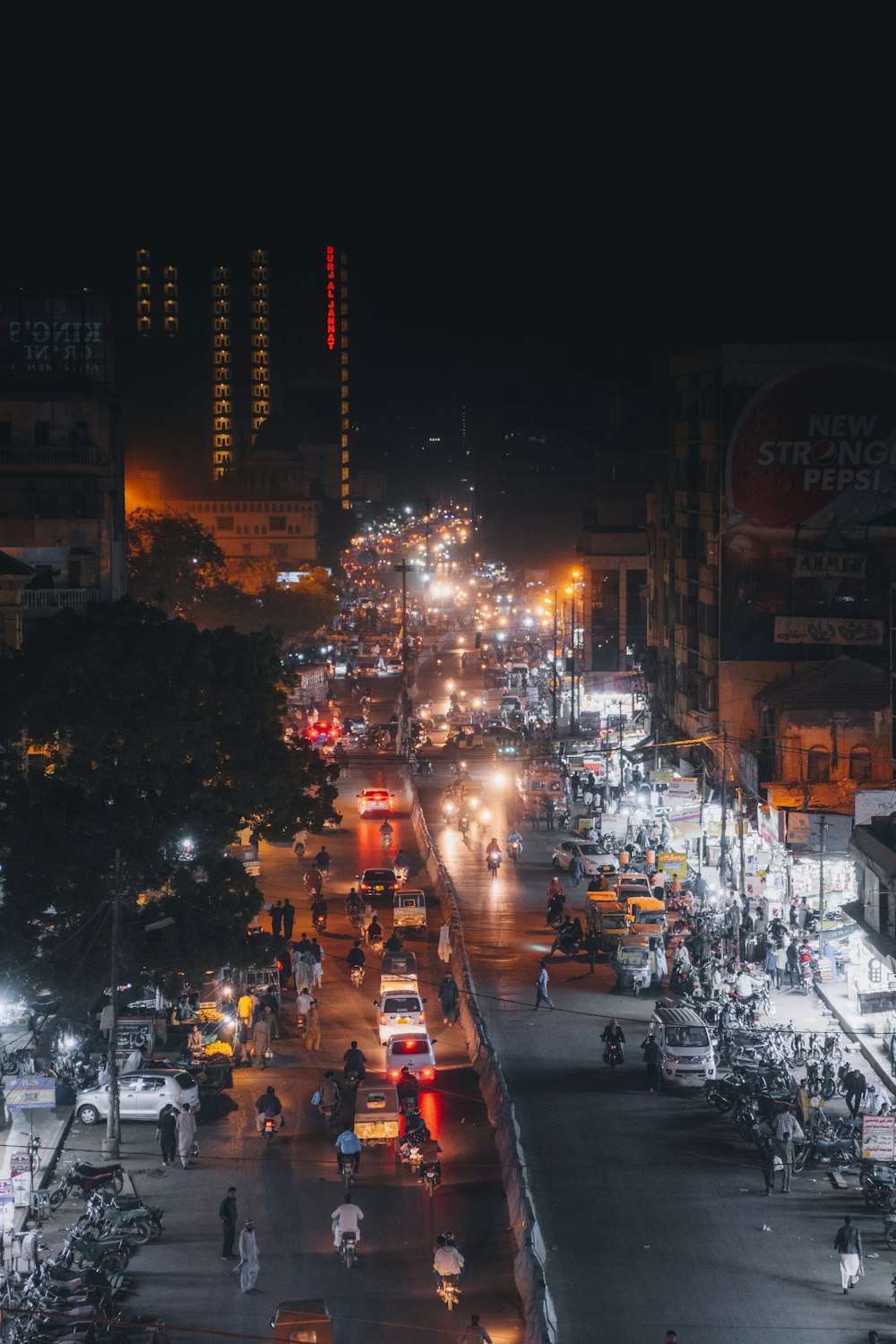 a city street filled with lots of traffic at night