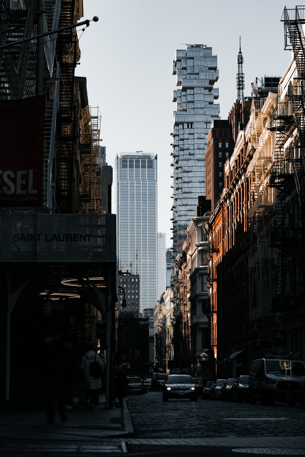 a city street with tall buildings in the background