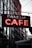 Neon signboard of a cafe with the name 'FANELLI CAFE' in bright red letters. The sign is suspended with chains against the backdrop of tall buildings in an urban setting.