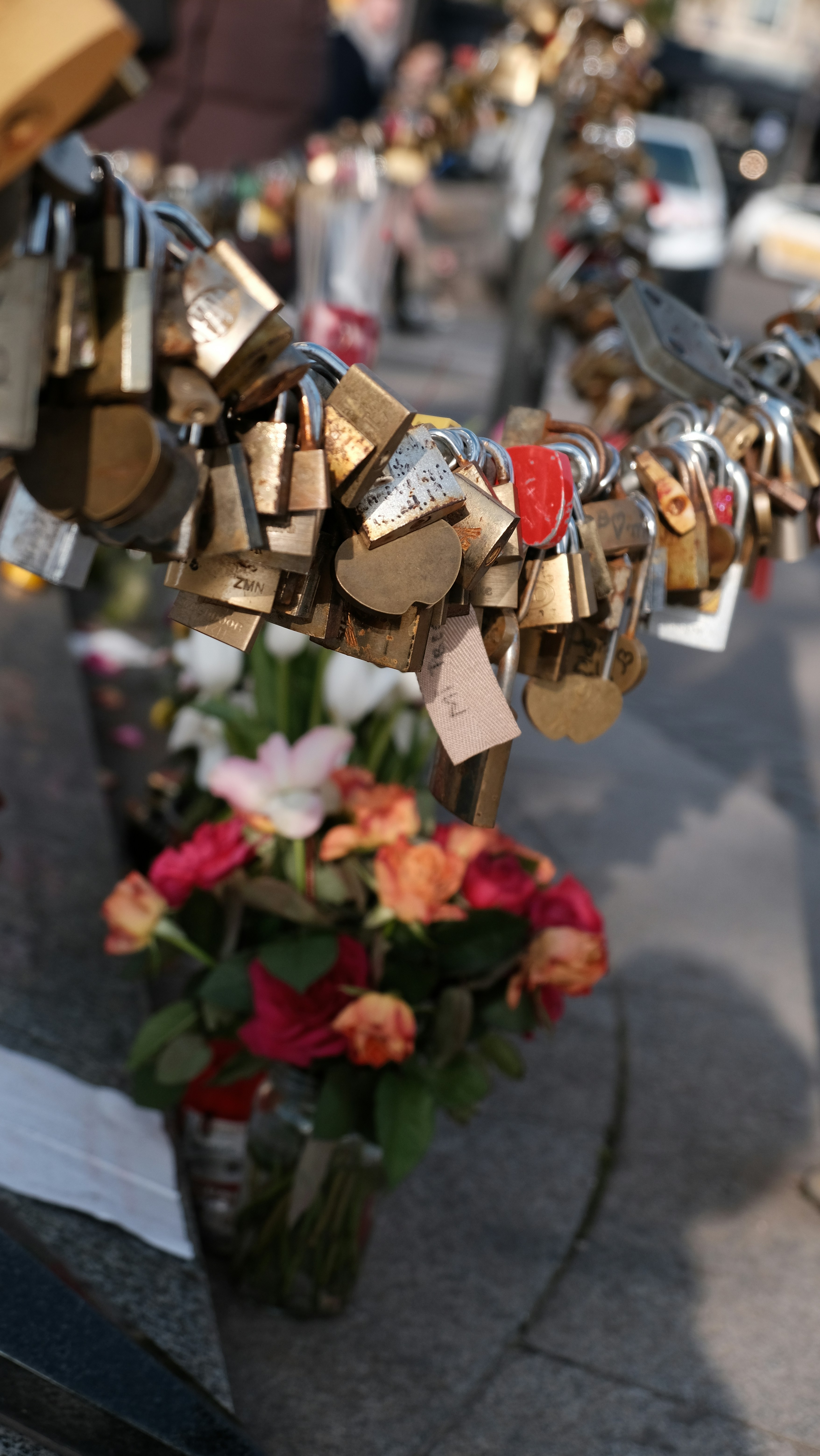 a bunch of padlocks attached to a fence