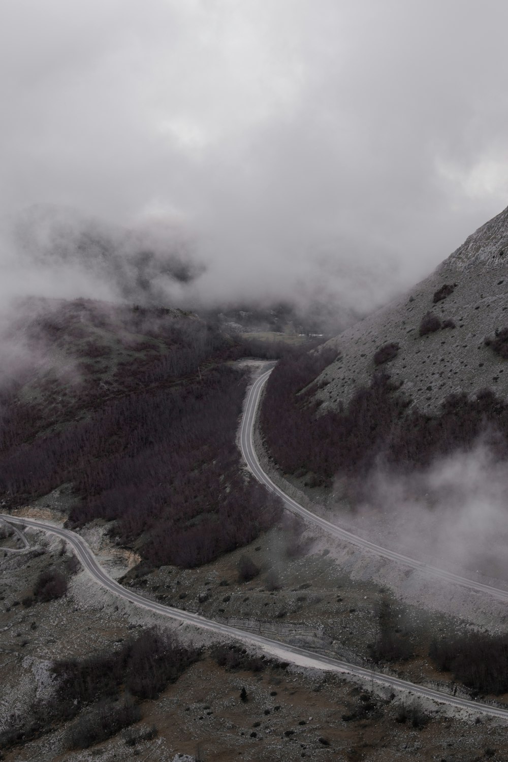 a winding road in the middle of a mountain