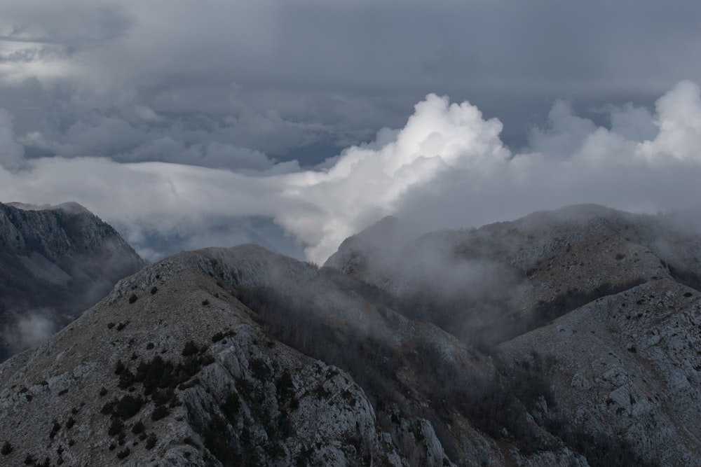 a view of some mountains with clouds in the sky