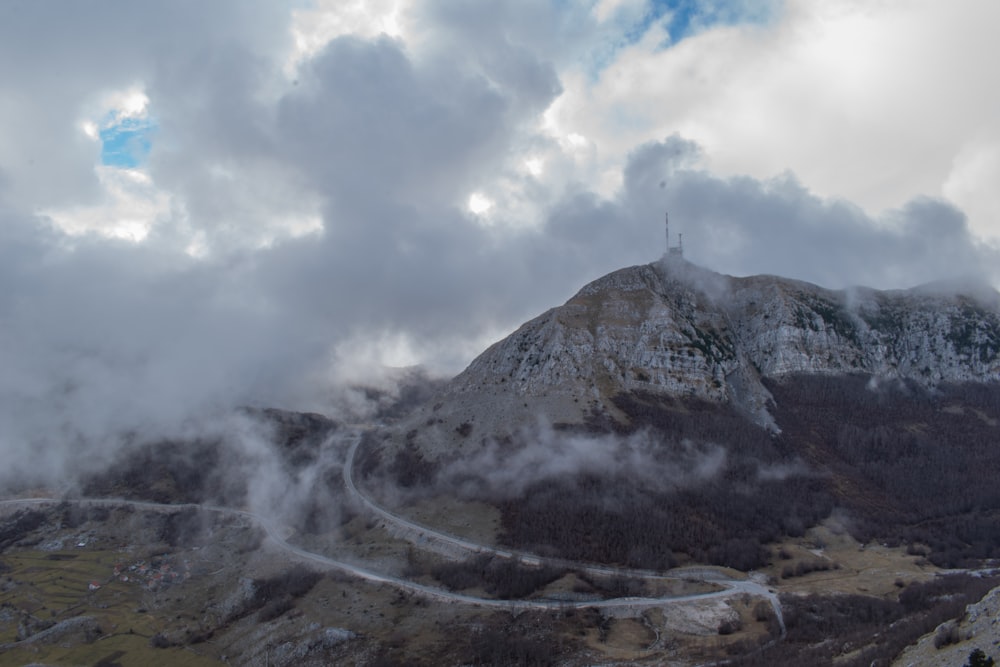 a view of a mountain with clouds in the sky