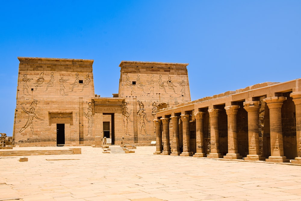 a large building with columns and a sky background