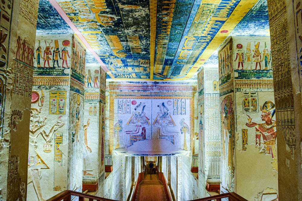 a room with egyptian paintings and paintings on the walls