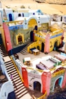a colorfully painted building with stairs leading up to it