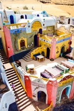 a colorfully painted building with stairs leading up to it