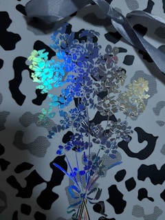 An elegant branded print display featuring refined metallic gold details on a black-and-white cow pattern.