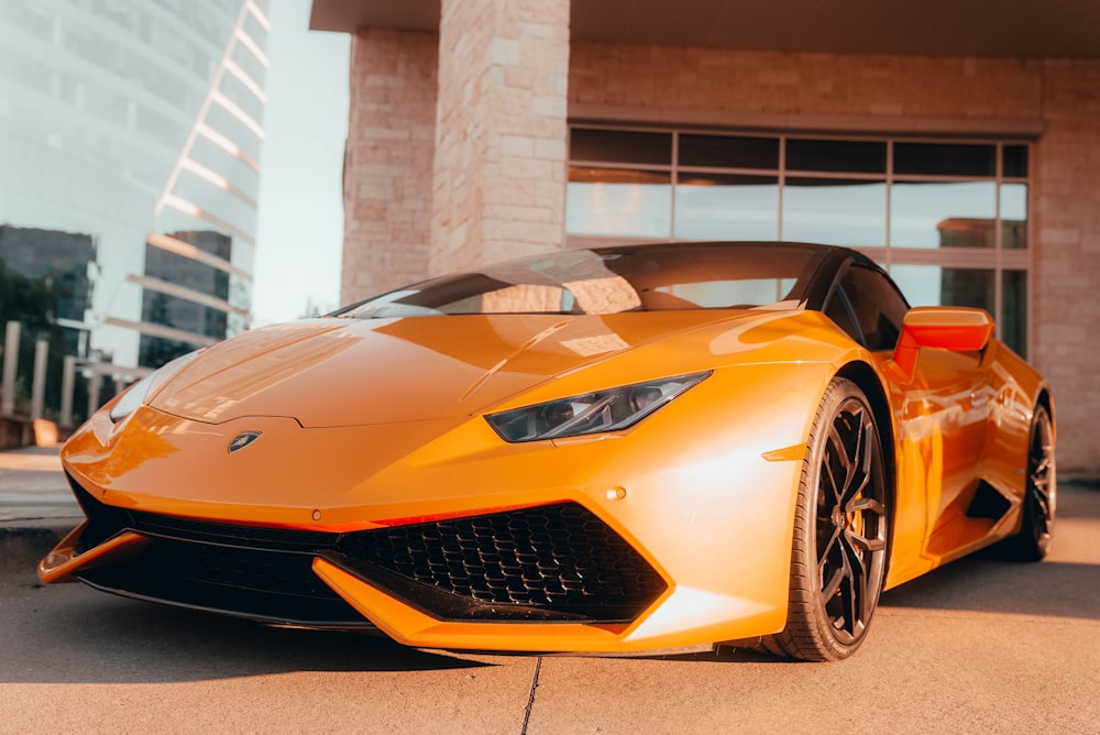 a yellow sports car parked in front of a building