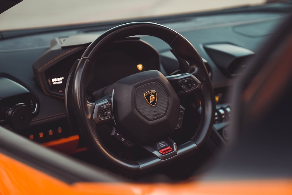 a close up of a steering wheel and dashboard of a sports car