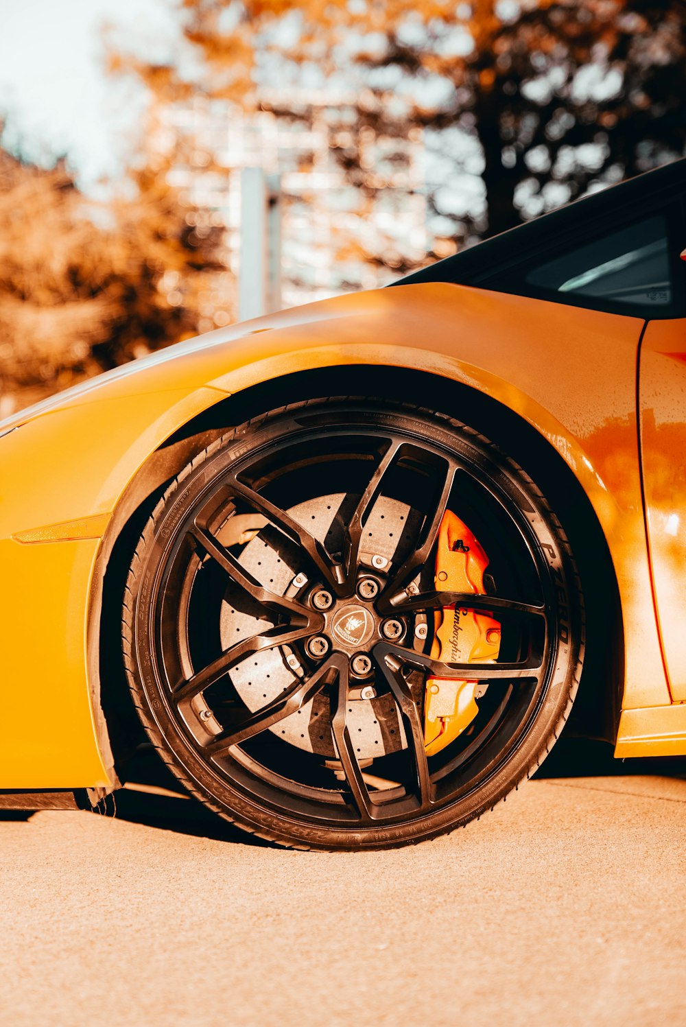 a yellow sports car parked on the side of the road