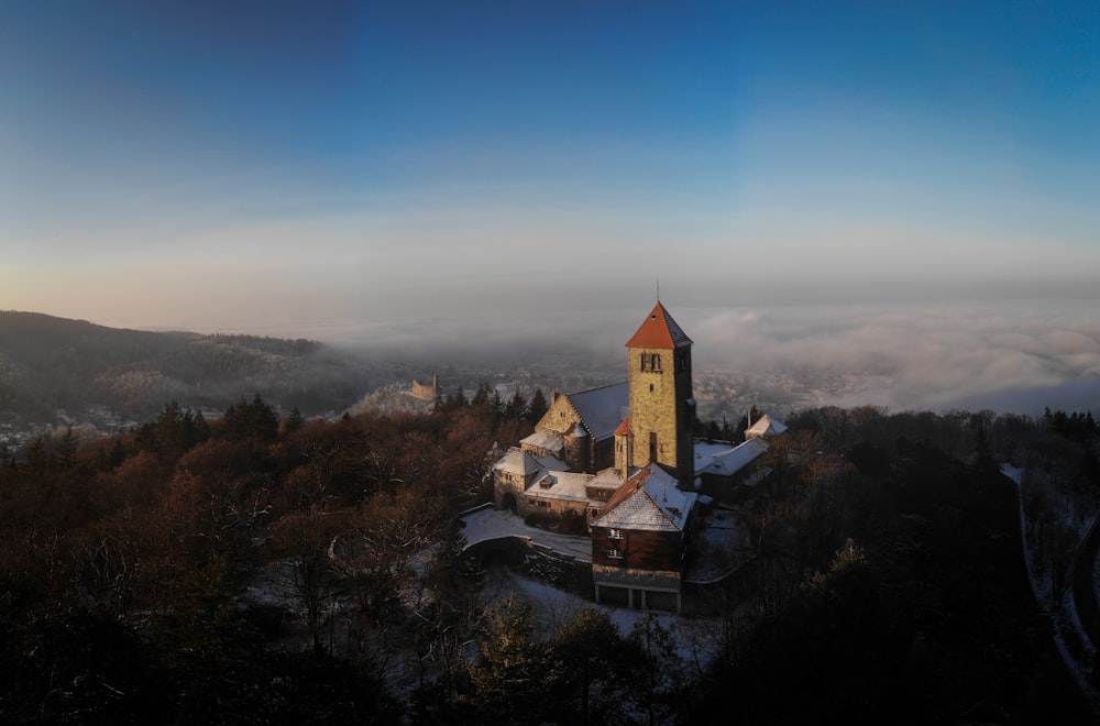 a church on top of a mountain surrounded by fog