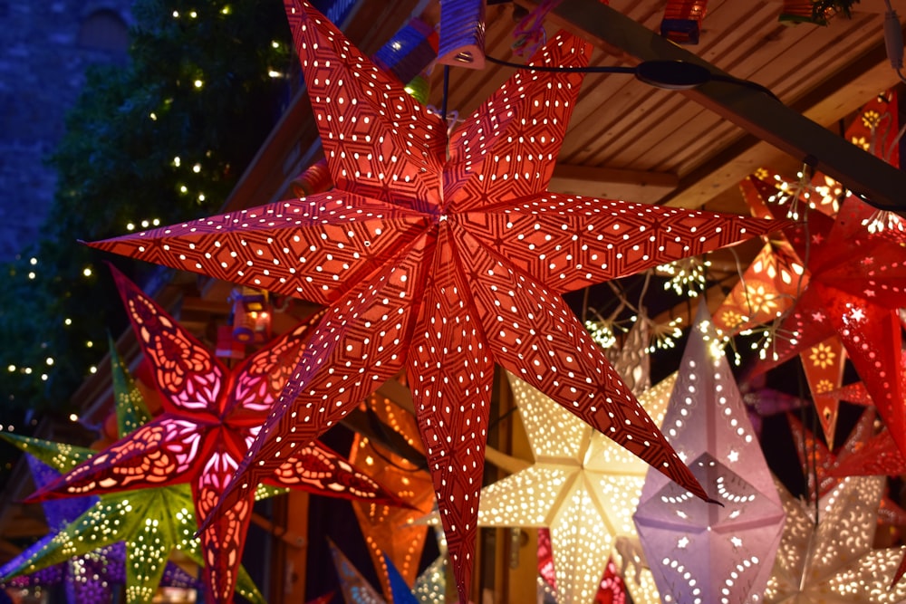 a group of paper stars hanging from a ceiling