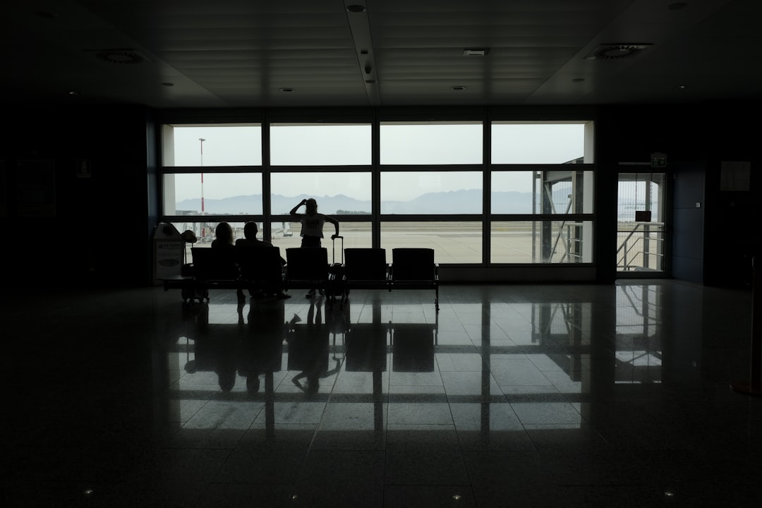 a group of people sitting in a waiting area,