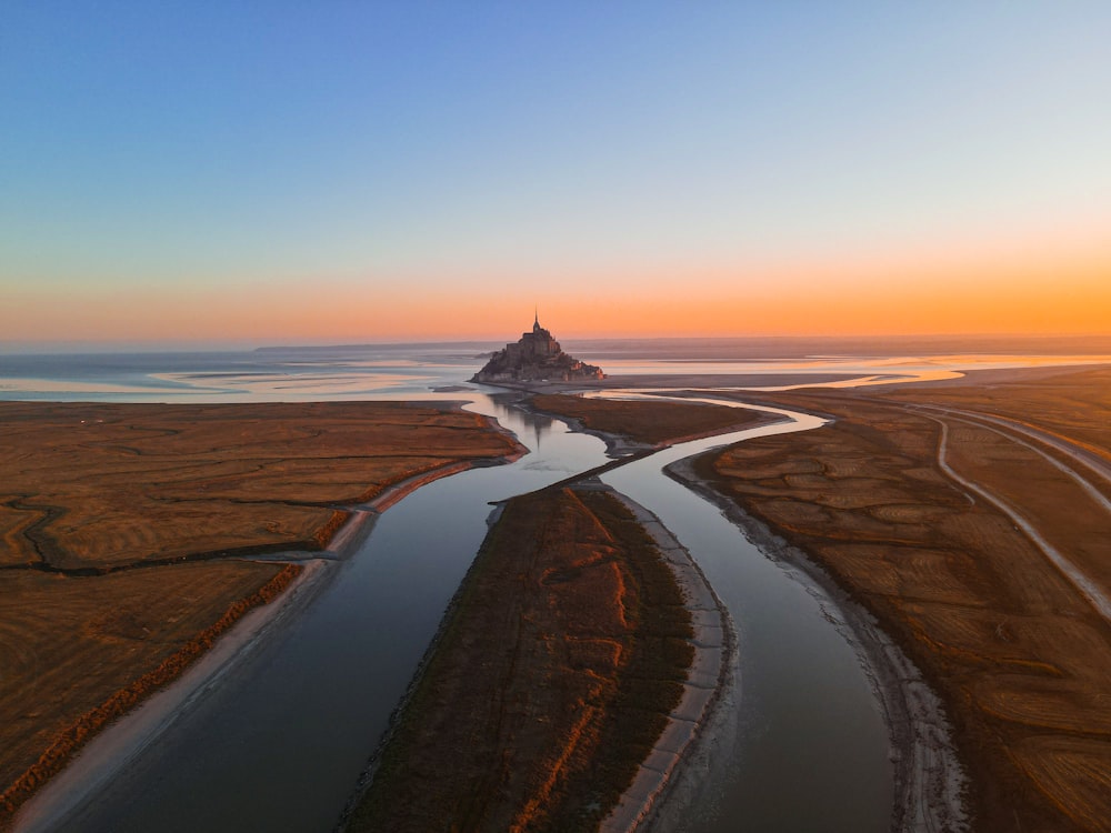 an aerial view of a river running through a field