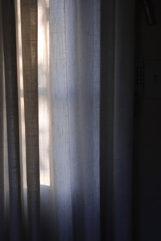 Elegant curtain panels softly lit by natural sunlight in a bright room