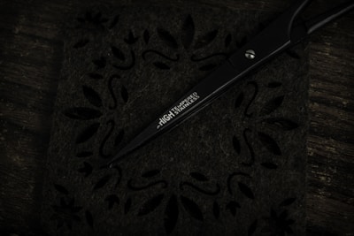 Close-up of finely crafted stainless steel surgical scissors resting on a clean white surface.