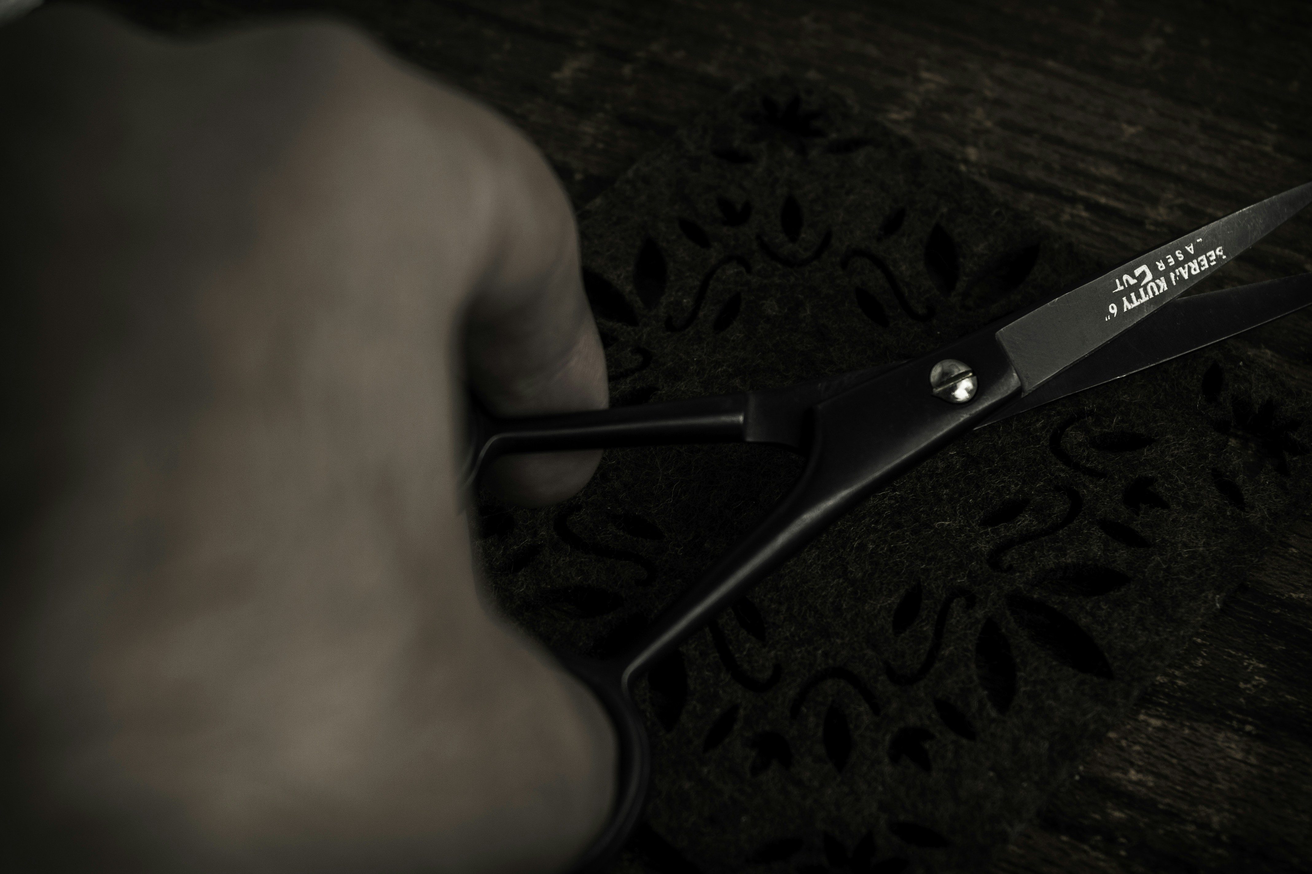 a person holding a pair of scissors in their hand