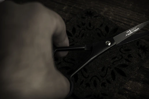 Close-up of a shiny pair of scissors cutting through fabric with precision.