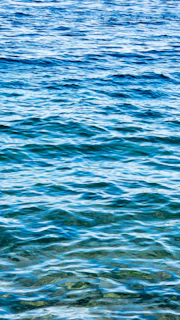 Deep blue waves of chakra energy radiating from a peaceful meditator.