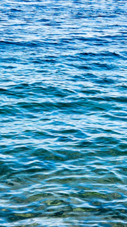 Deep blue waves of chakra energy radiating from a peaceful meditator.