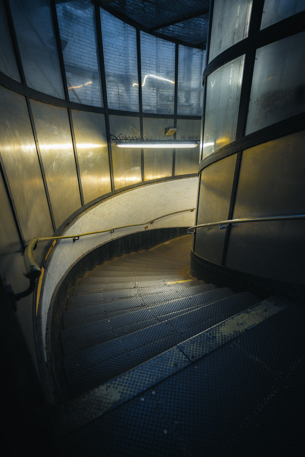 an escalator in a building with glass walls