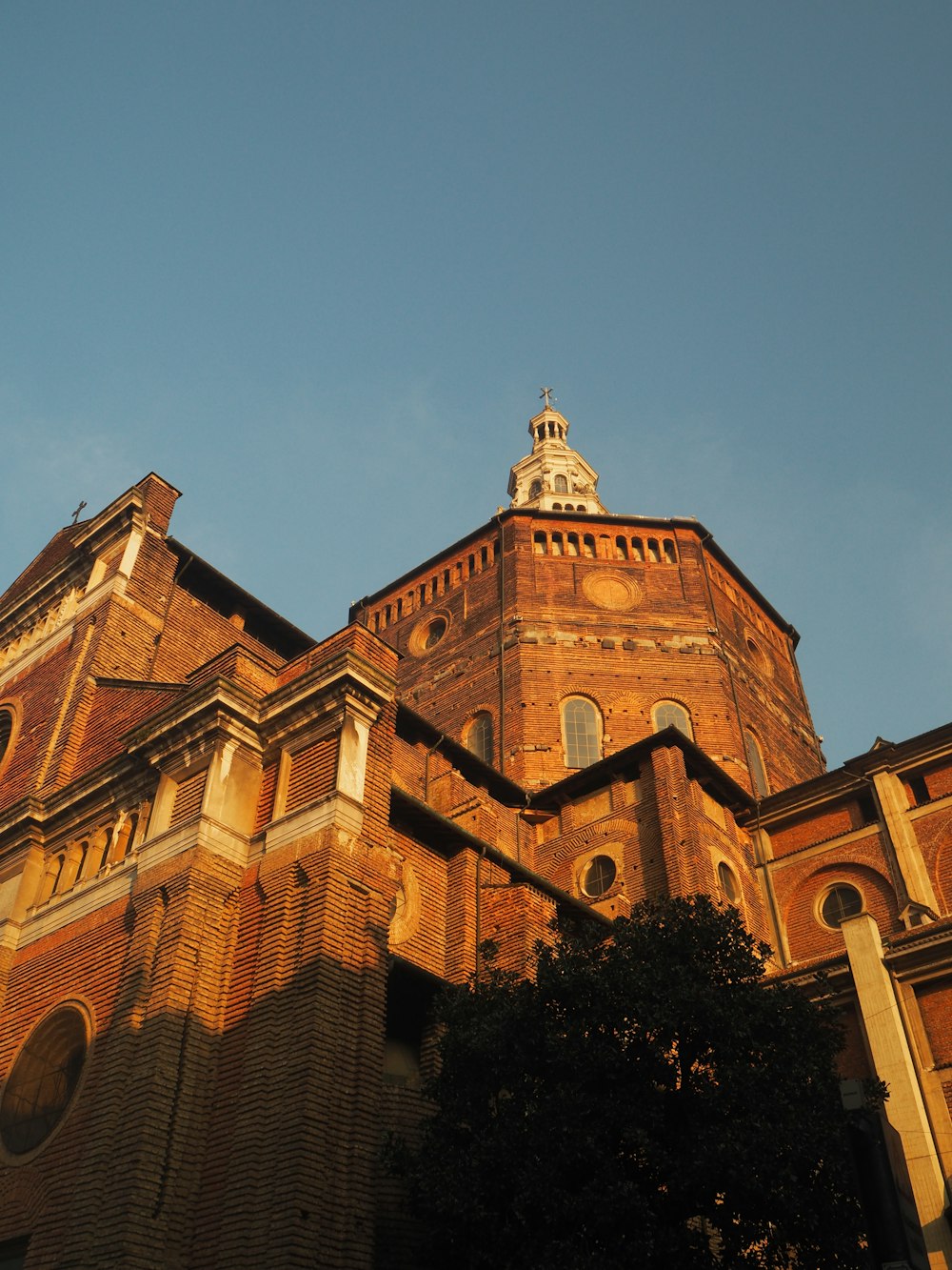 a tall brick building with a clock on the top of it