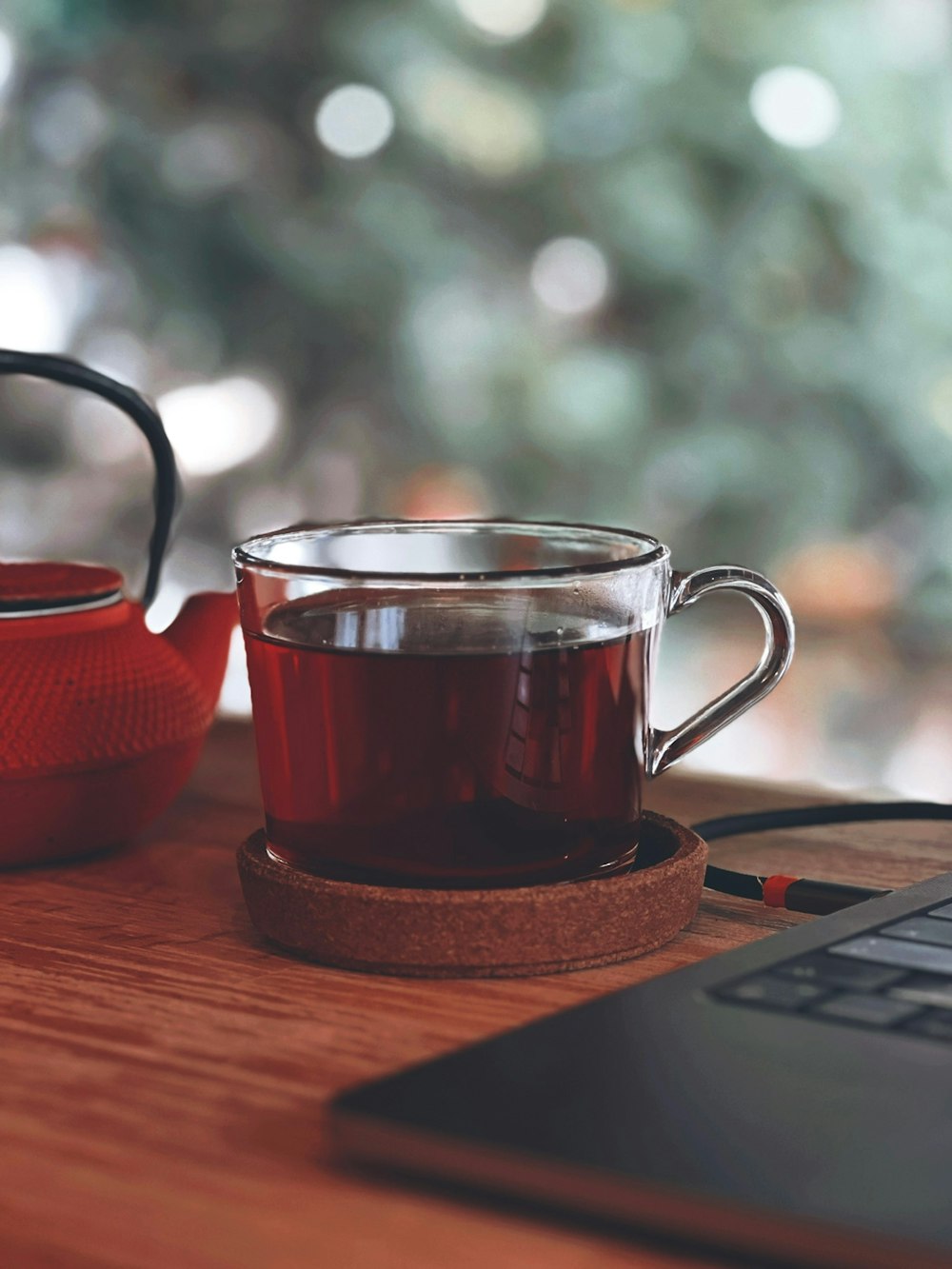 a cup of tea next to a laptop computer